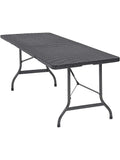 Table de jardin pliante 4 personnes en plastique aspect polyrotin sur une terrasse